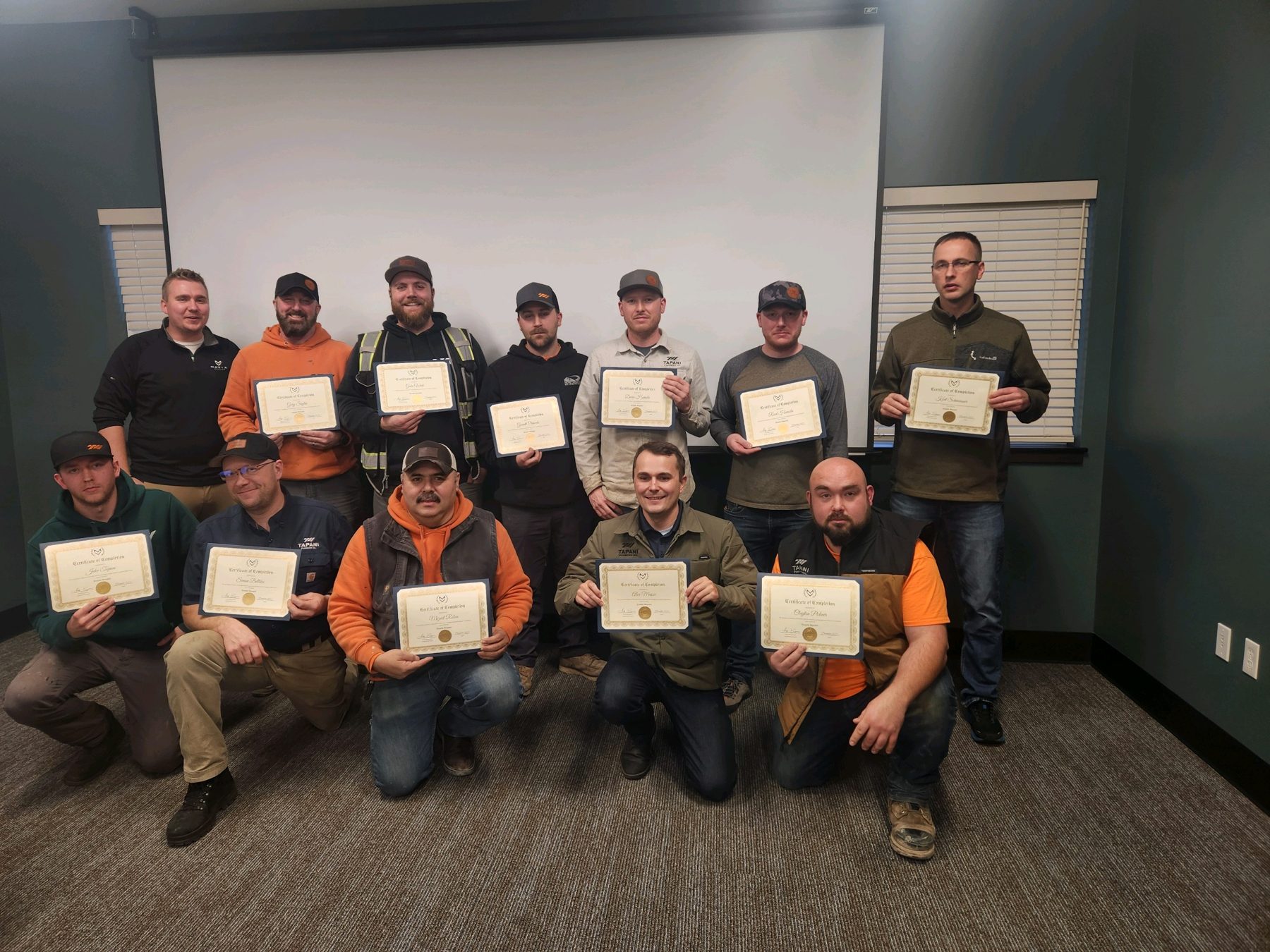 Tapani Plumbing leaders holding certificates of completion