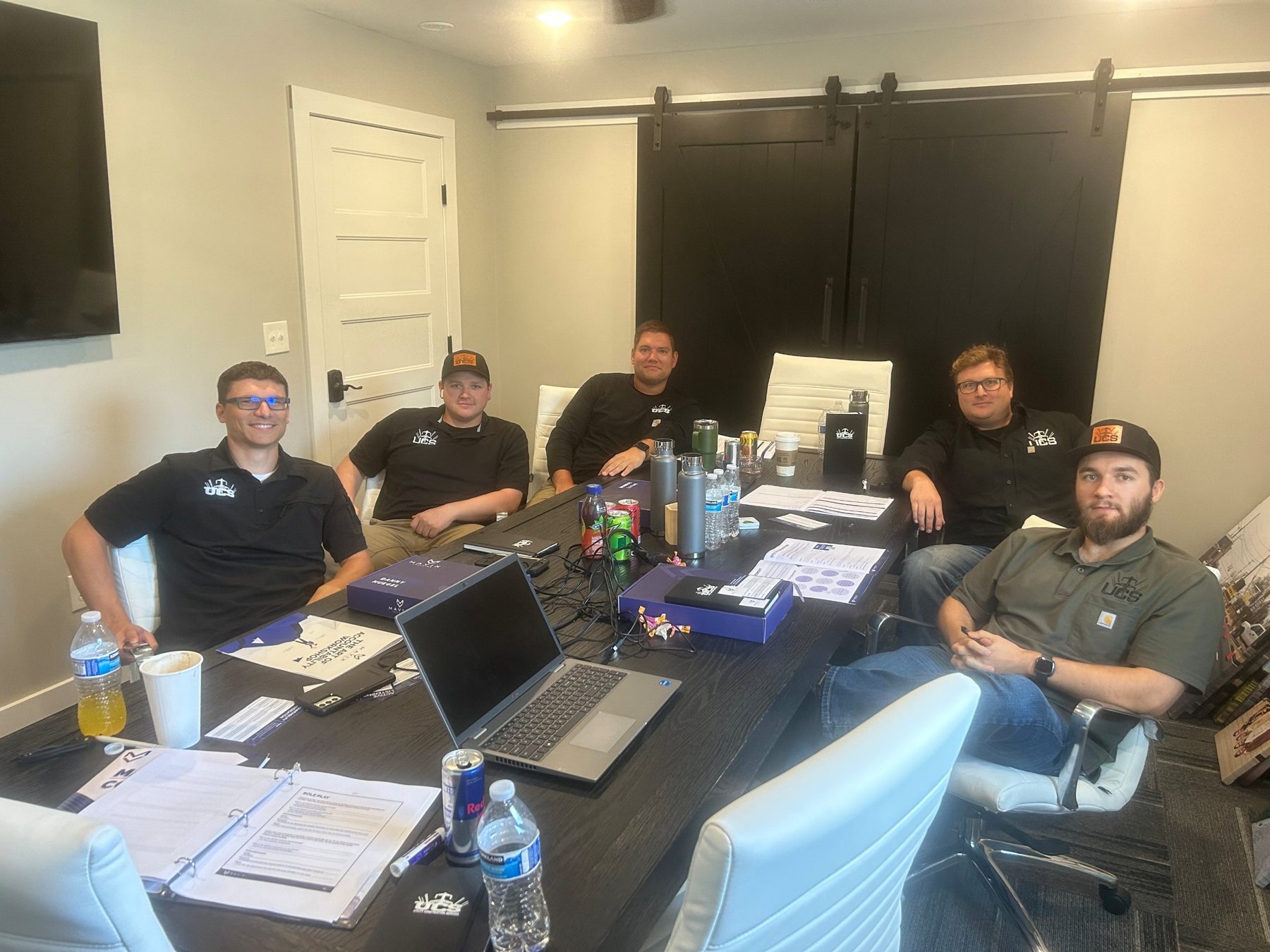 Utility Construction Services leaders around a training table