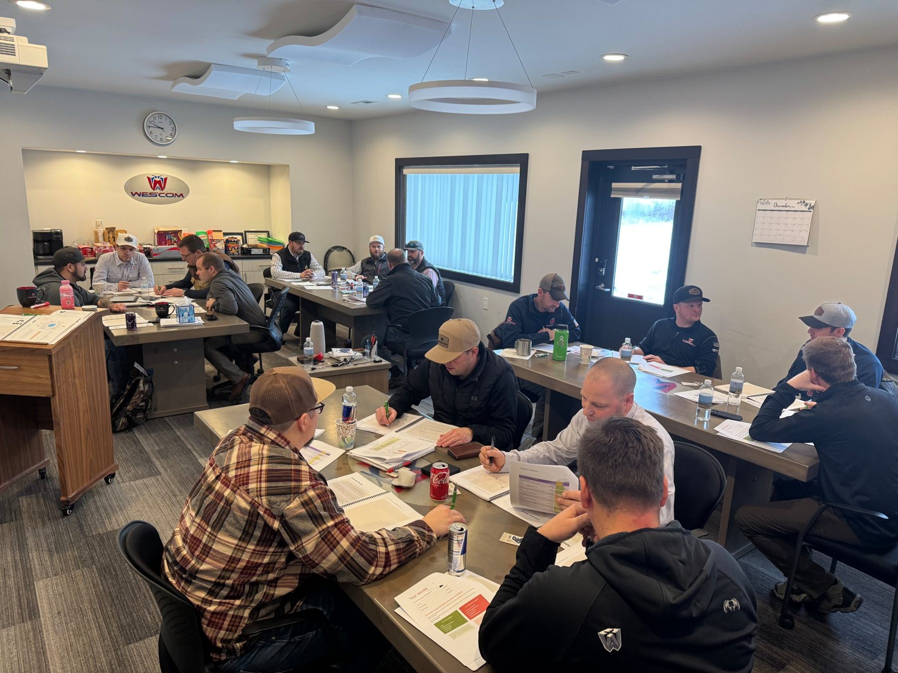 Wescom leaders working through training materials at tables